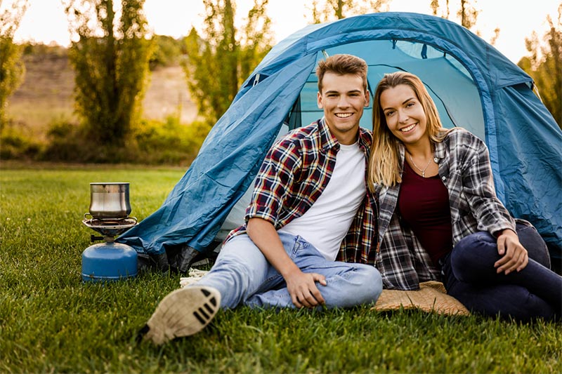 Young-couple-enjoying-summer-camping-time